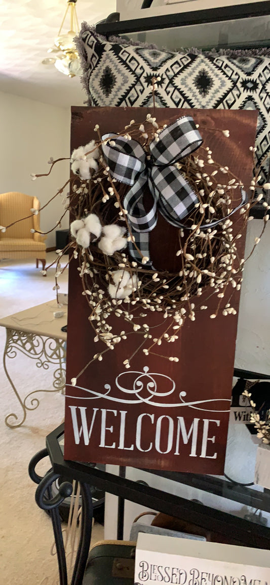 Wood welcome sign with berry wreath